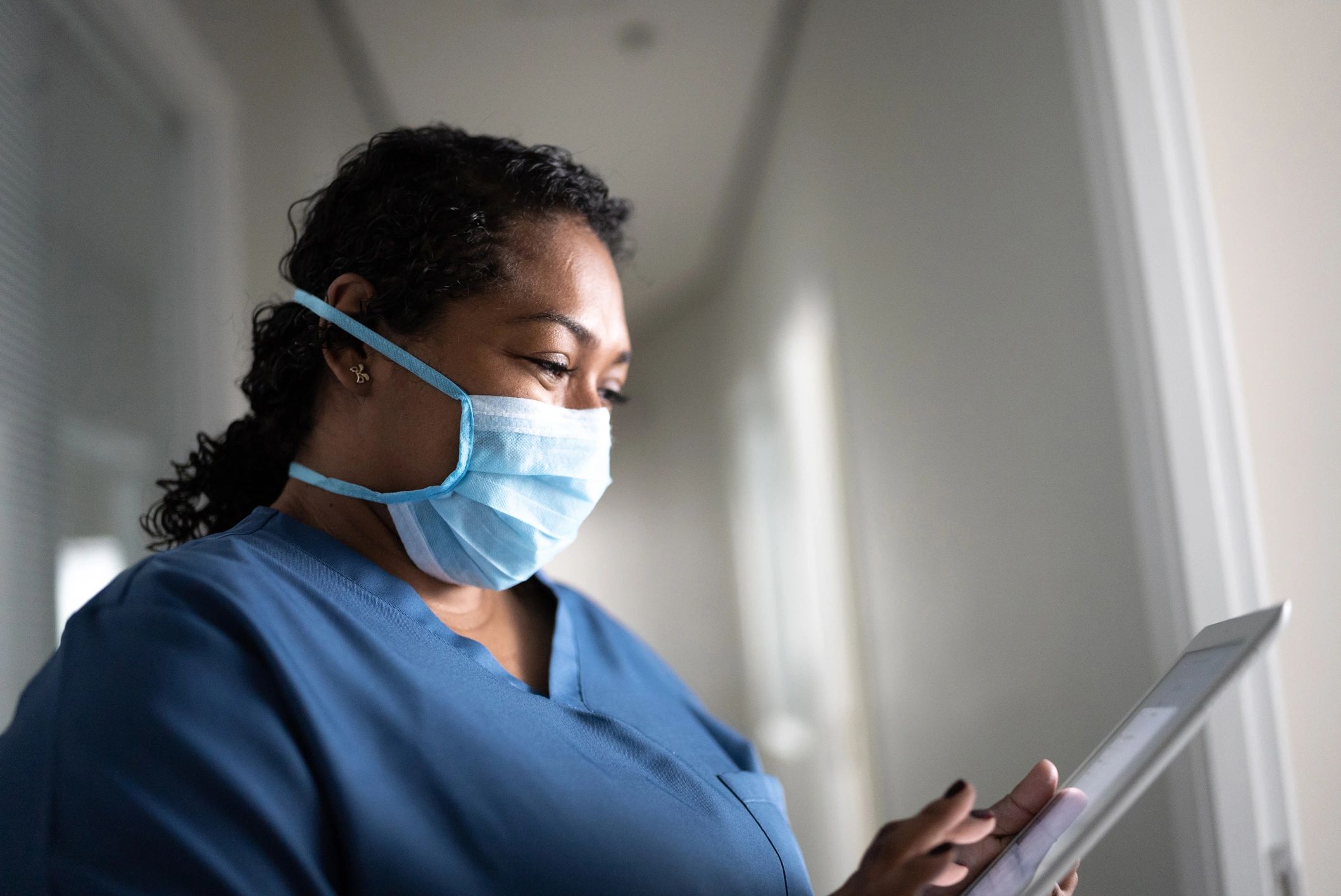 Healthcare worker using a tablet in a hospital setting