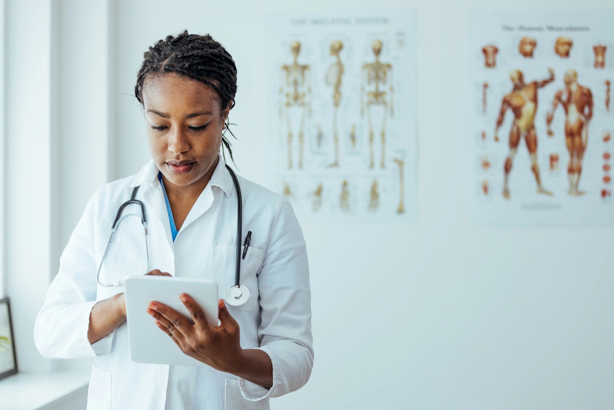 Doctor using a tablet to review electronic health records