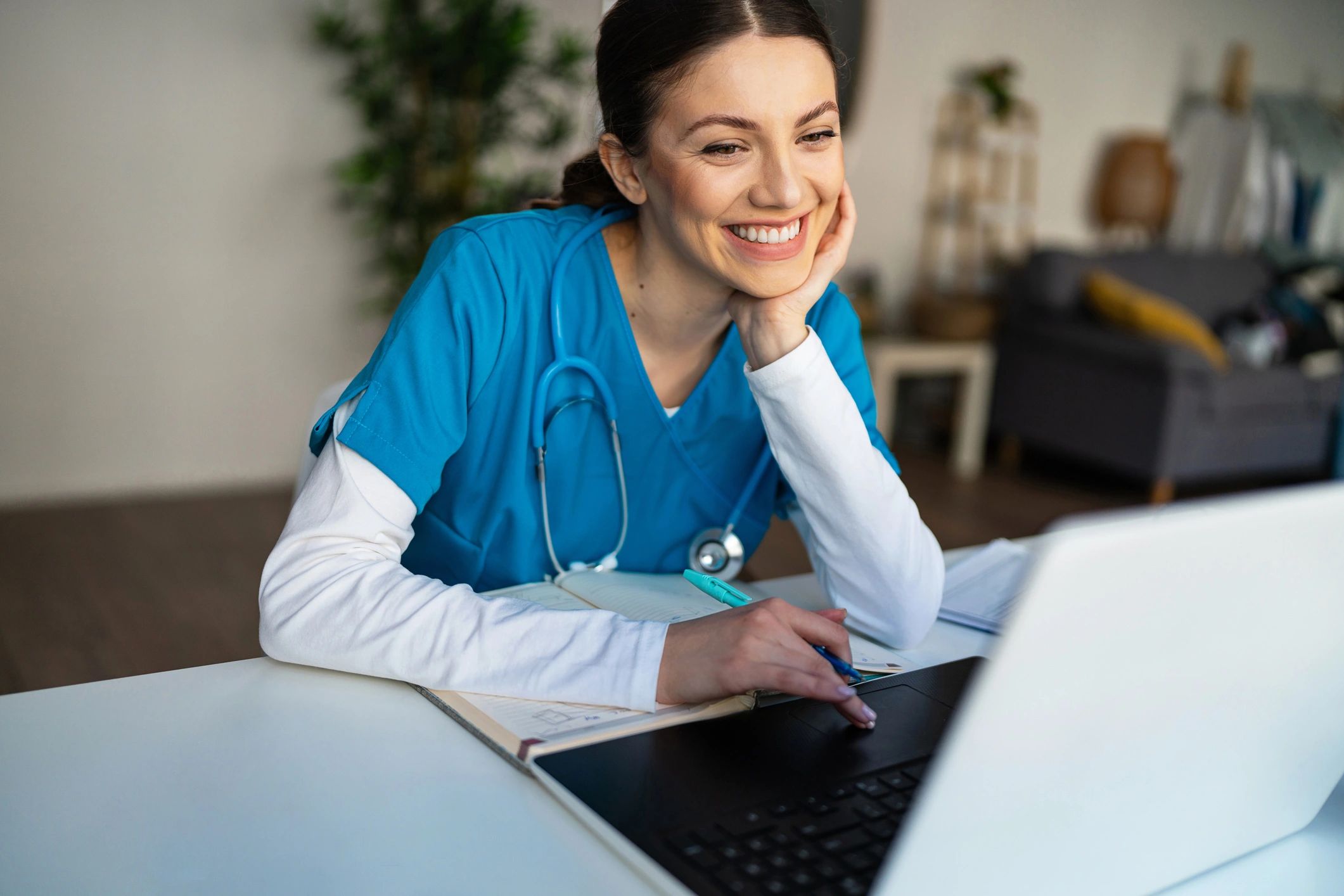 Healthcare professional working on a laptop in a clinic office