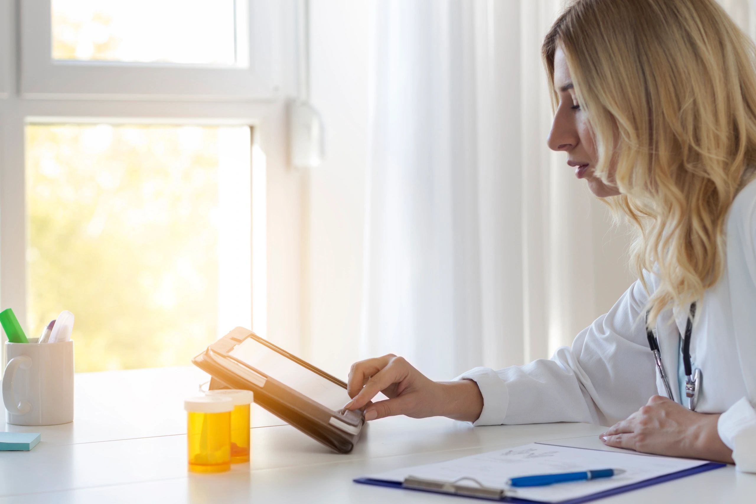 Clinician using a tablet to review electronic health records